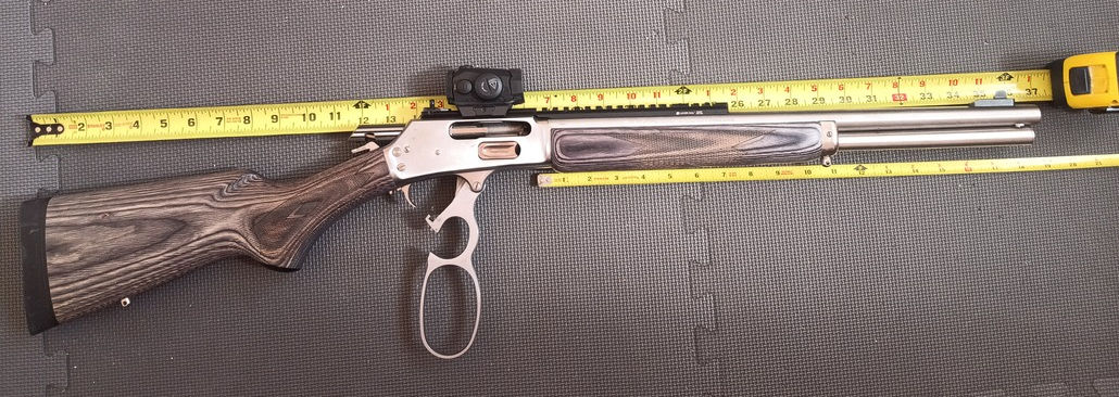 Marlin 1895 Guide Gun, on exercise mats, with the action open and measuring tapes showing how long the barrel and overall firearm is.
